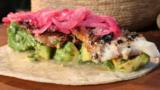 Crisp sea bass tortillas with pink pickled onion