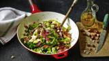 Spring greens with bacon and hazelnuts