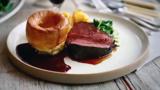 Treacle-cured beef with Yorkshire puddings and roast potatoes