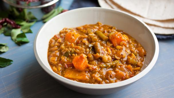 Spicy lentil soup with squash, tomato and green beans (sambar)
