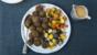 Apricot, chestnut and aduki balls with roasted vegetables and white wine miso gravy