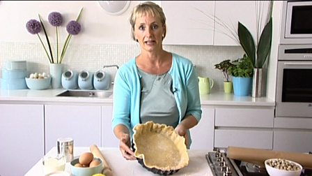 Lining a tart tin with pastry