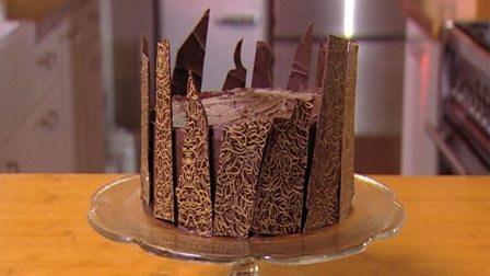 Decorating a cake with chocolate transfer sheets